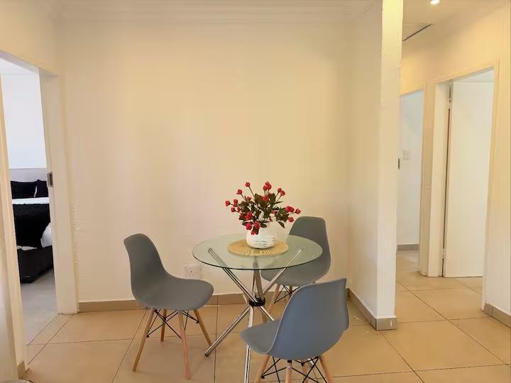 Dining nook with round glass table, off the entrance hallway